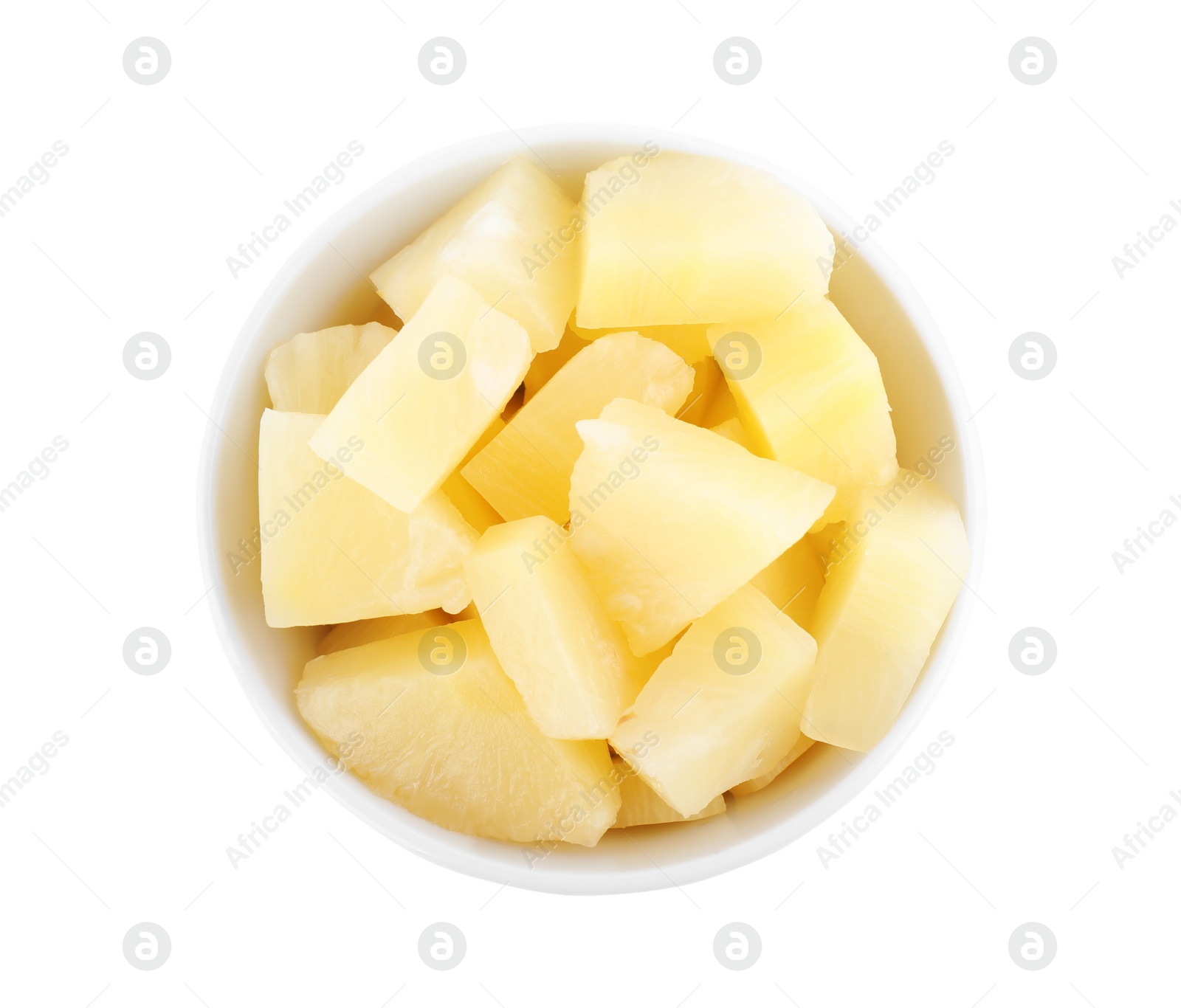 Photo of Pieces of delicious canned pineapple in bowl on white background, top view