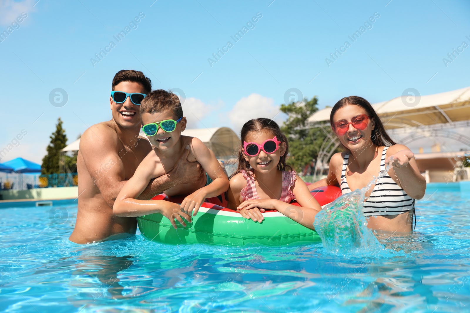 Photo of Happy family in swimming pool. Summer vacation