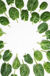 Frame made of spinach leaves on white background, top view. Space for text