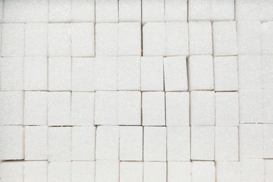 Photo of White sugar cubes as background, top view