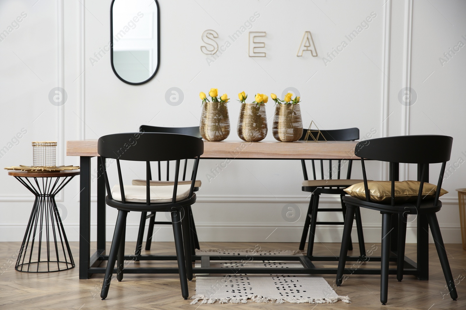 Photo of Stylish wooden dining table and chairs in room. Interior design