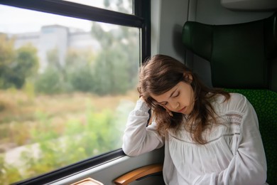 Photo of Teenage girl sleeping in train during trip