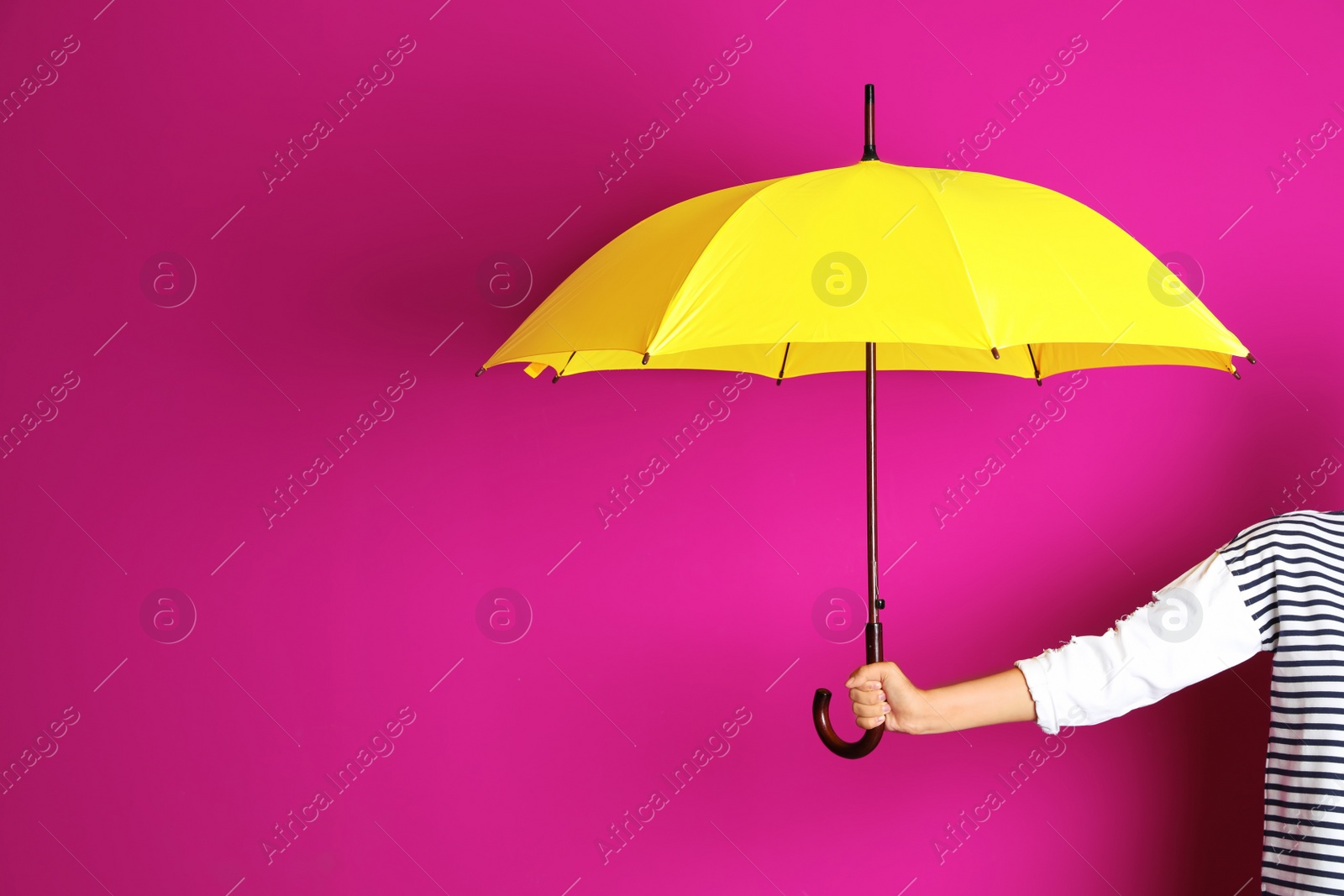 Photo of Woman holding beautiful umbrella on color background with space for design