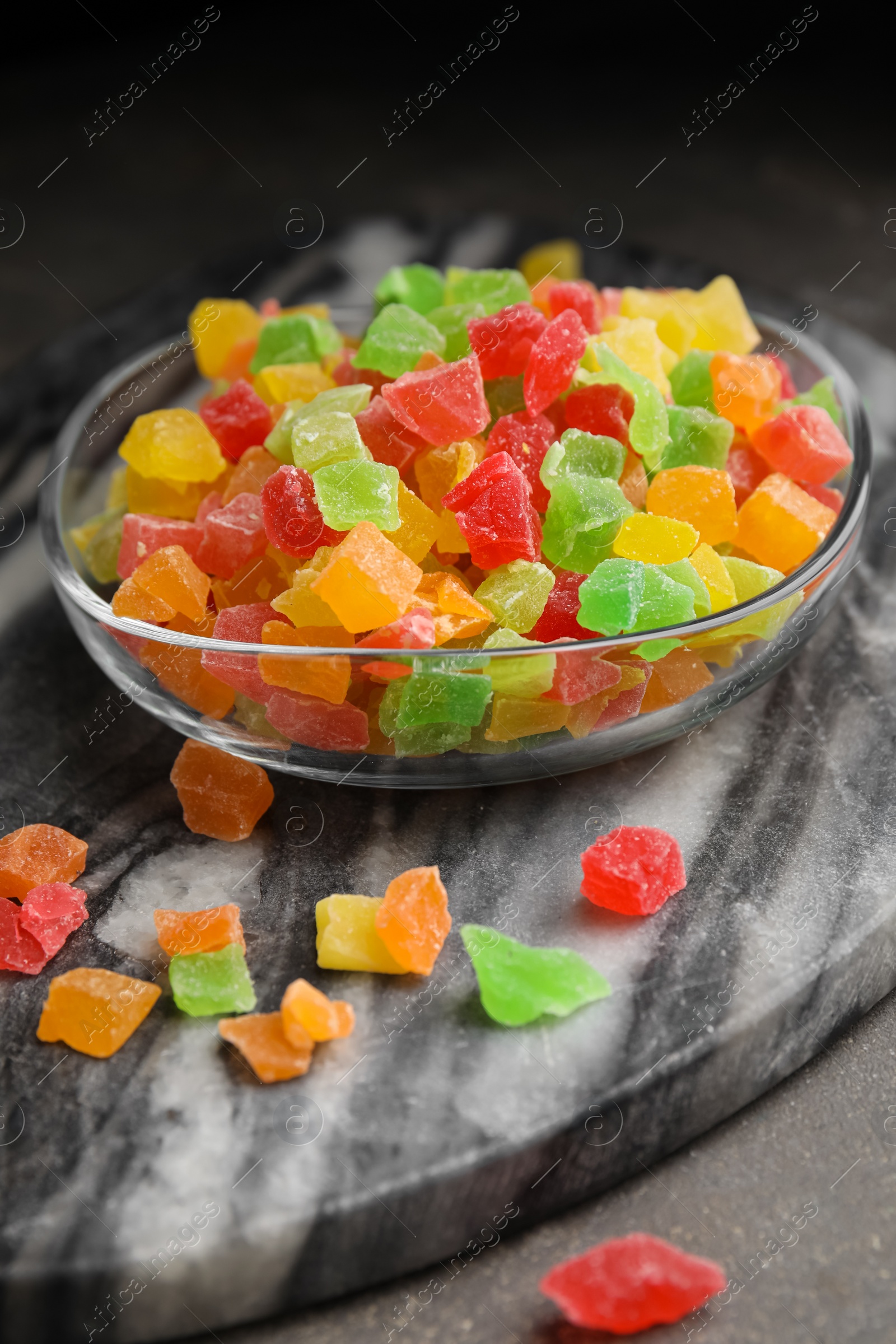 Photo of Mix of delicious candied fruits on marble board, closeup