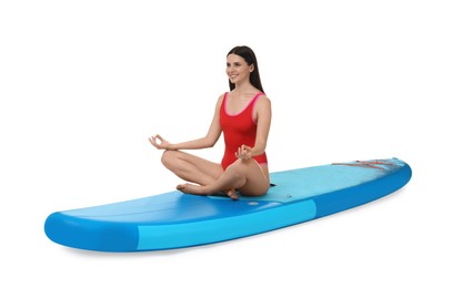 Happy woman practicing yoga on blue SUP board against white background