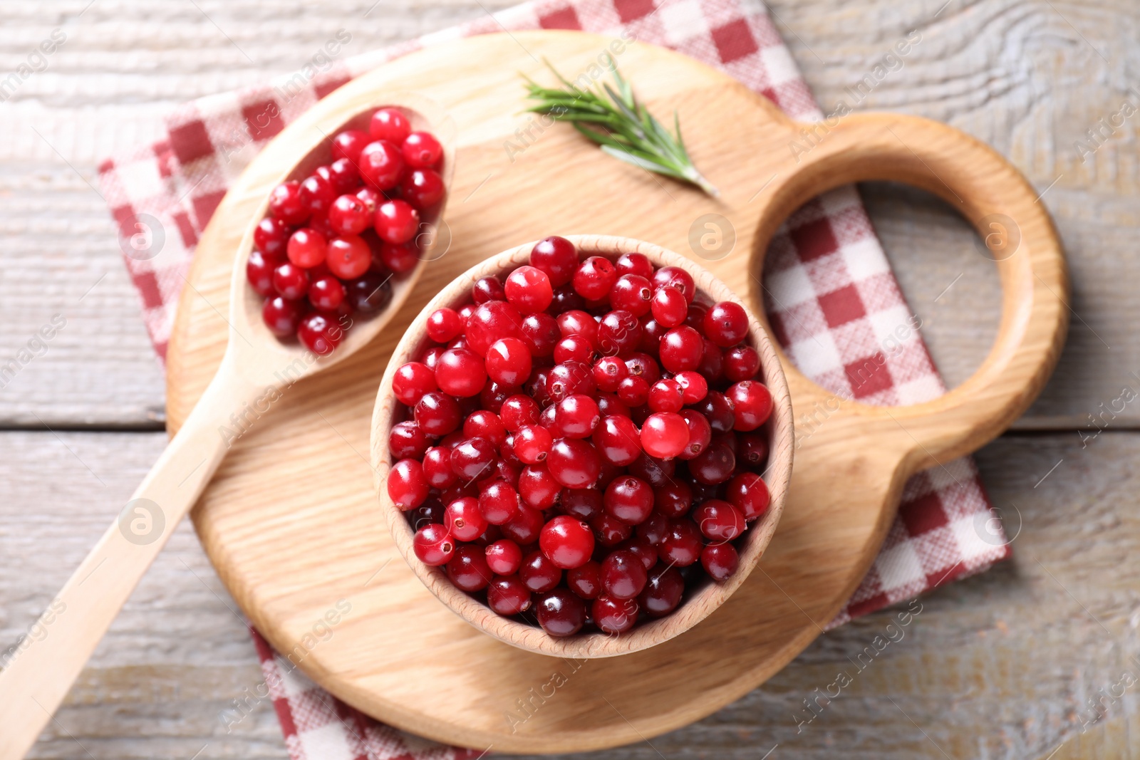 Photo of Fresh ripe cranberries on wooden table, top view