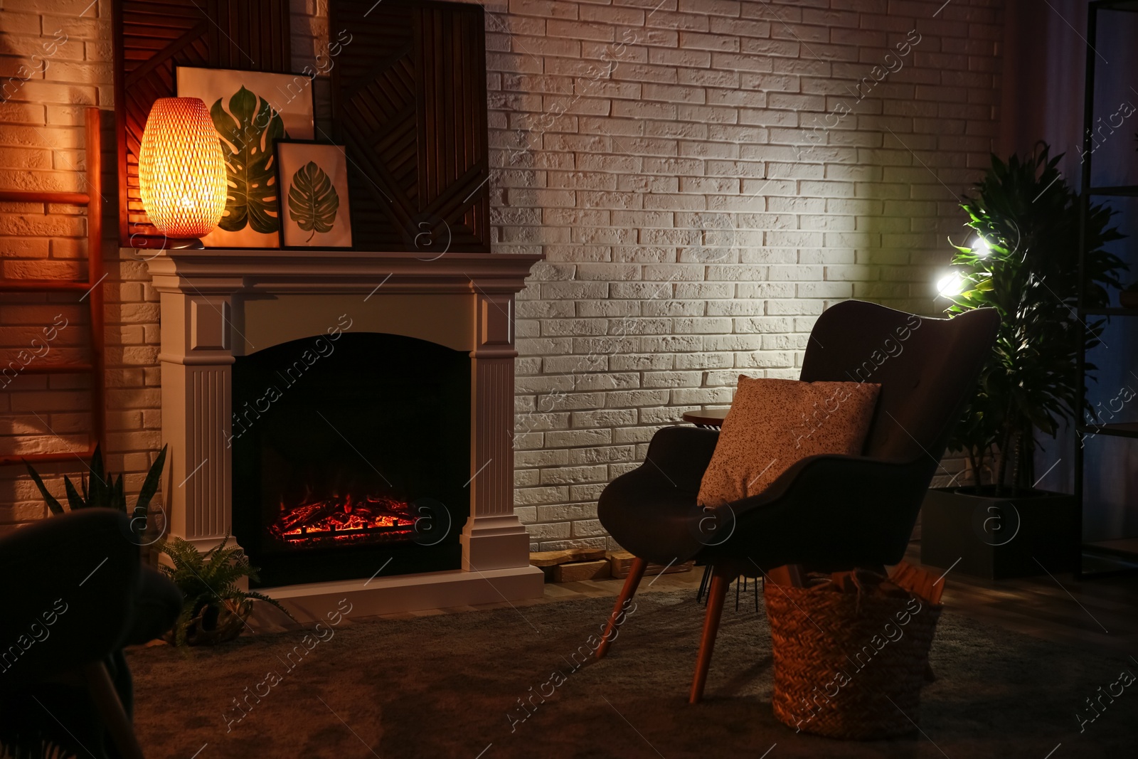 Photo of Living room interior with decorative fireplace near white brick wall