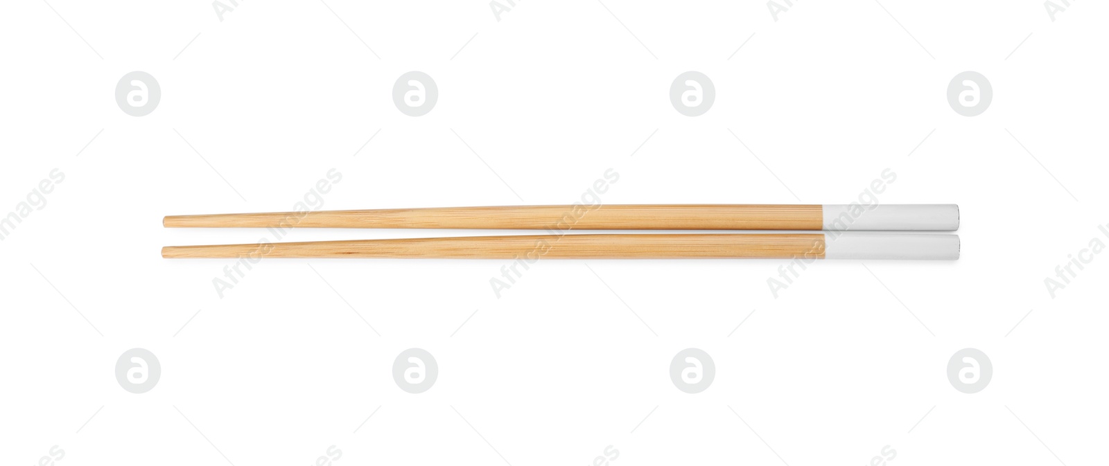 Photo of Pair of wooden chopsticks isolated on white, top view