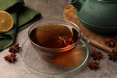 Photo of Aromatic tea with anise stars on light grey table
