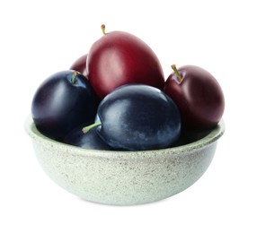 Bowl of delicious ripe plums on white background