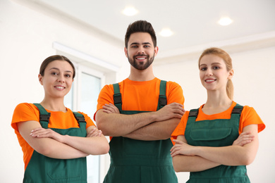 Photo of Team of professional janitors indoors. Cleaning service