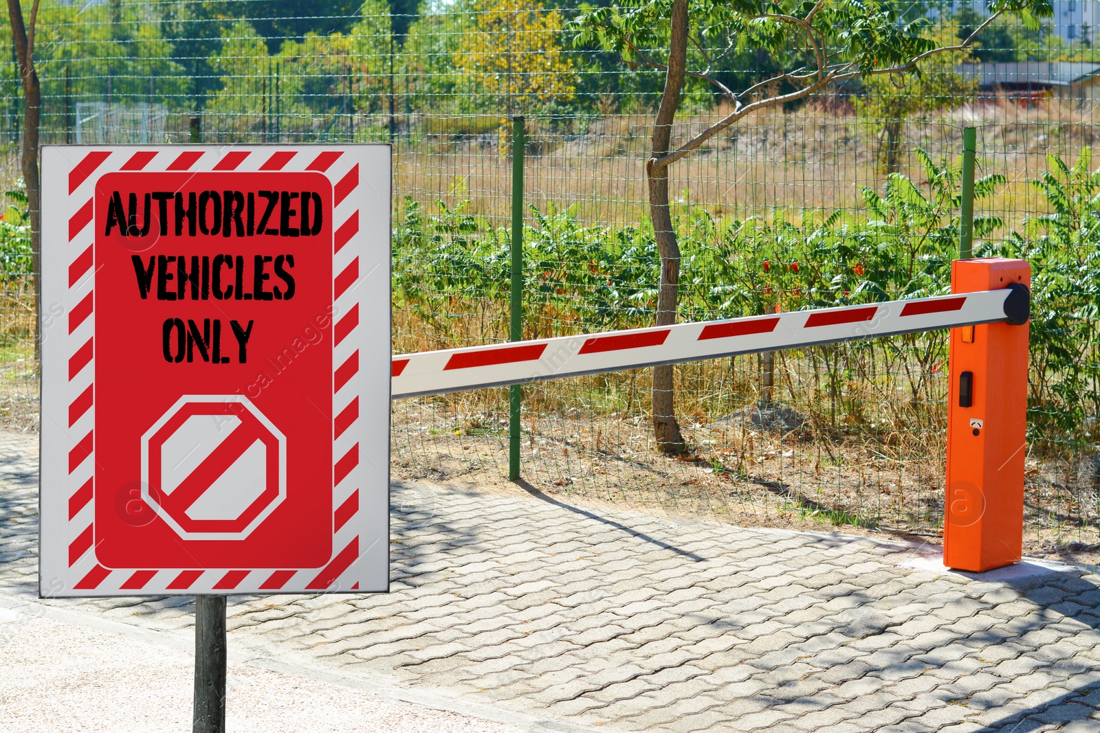 Image of Sign with text Authorized Vehicles Only near boom barrier outdoors