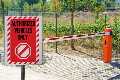 Image of Sign with text Authorized Vehicles Only near boom barrier outdoors