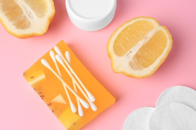 Photo of Lemon face wash. Fresh citrus fruits and personal care products on pink background, flat lay