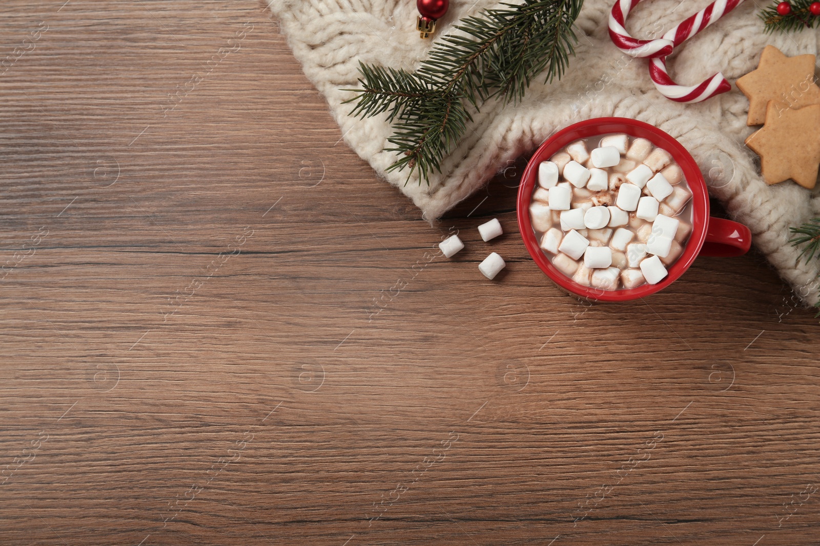 Photo of Flat lay composition with marshmallows, hot drink and plaid on wooden table. Space for text