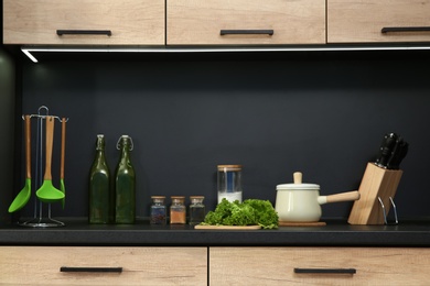 Photo of Stylish kitchen counter with houseware and products