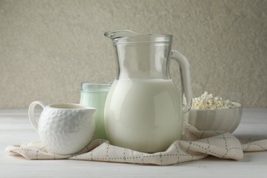 Photo of Lactose free dairy products on white wooden table