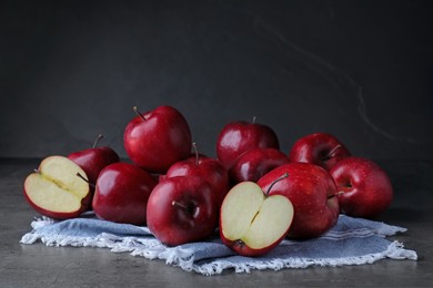 Photo of Fresh ripe red apples on grey table
