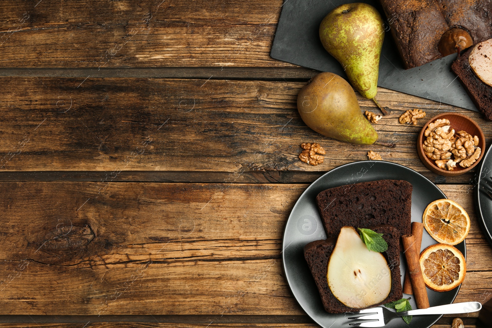 Photo of Flat lay composition with tasty pear bread on wooden table, space for text. Homemade cake