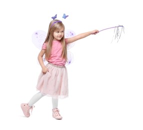 Cute little girl in fairy costume with violet wings and magic wand on white background