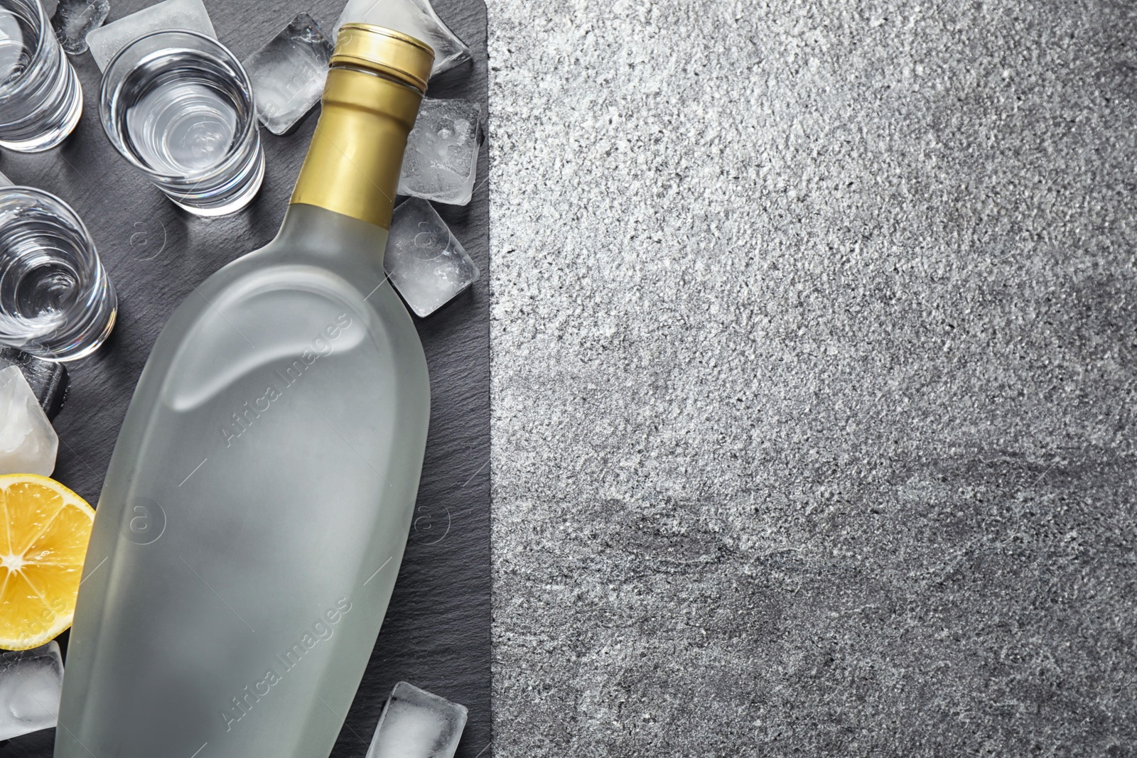 Photo of Cold Russian vodka on grey table, flat lay. Space for text