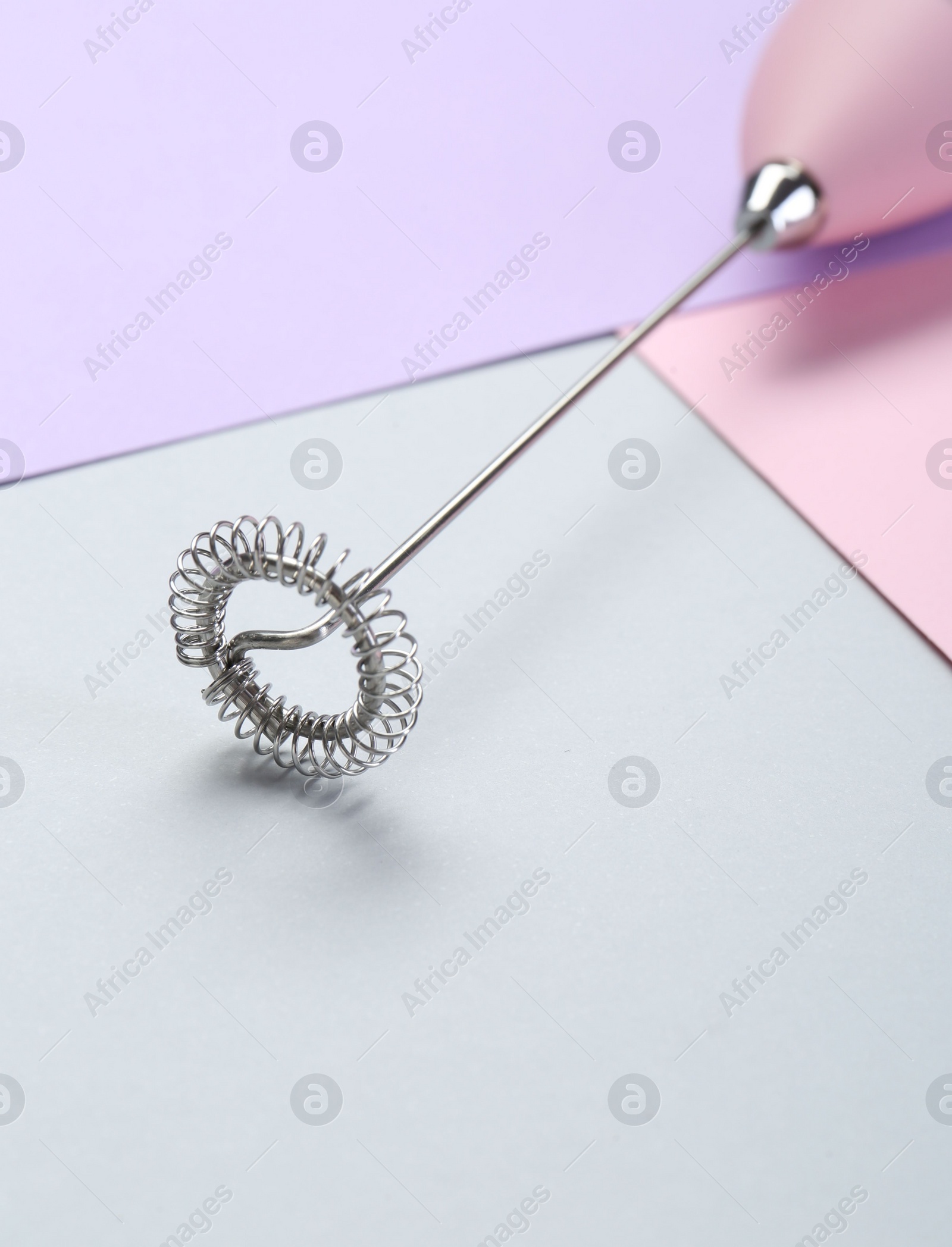 Photo of Pink milk frother wand on color background, closeup