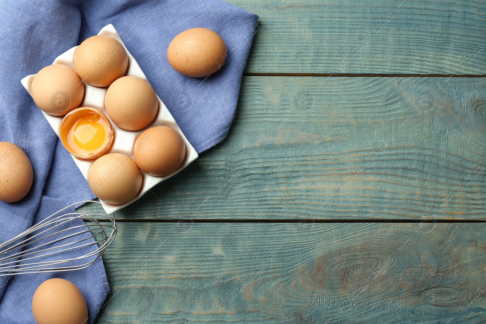 Photo of Flat lay composition with chicken eggs on blue wooden table. Space for text