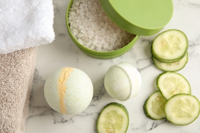 Photo of Flat lay composition with bath bombs, cosmetic salt and cucumber slices on color background