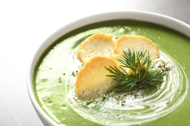 Fresh vegetable detox soup with croutons in dish, closeup