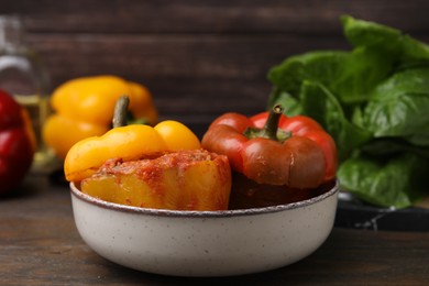 Photo of Delicious stuffed bell peppers on wooden table, closeup