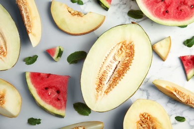 Photo of Flat lay composition with melon and watermelon on color background