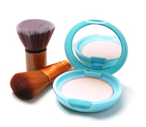 Face powder with makeup brushes on white background