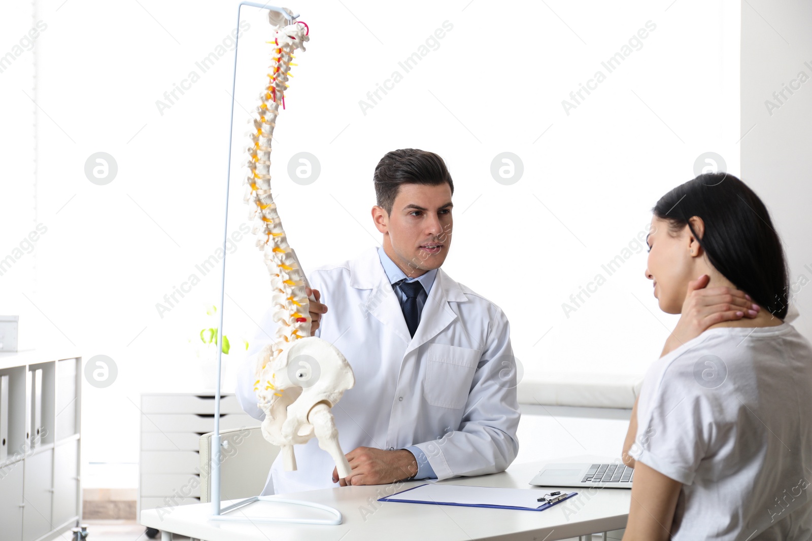 Photo of Young woman visiting orthopedist in medical office