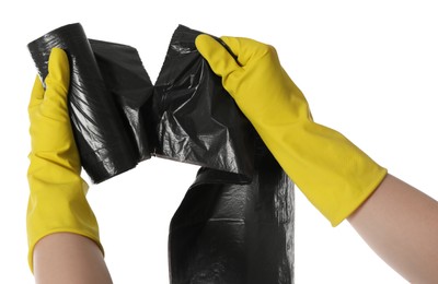 Photo of Janitor in rubber gloves ripping off black garbage bag from roll on white background, closeup