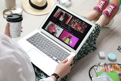 Photo of Fashion blogger with laptop on floor, closeup
