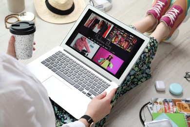 Fashion blogger with laptop on floor, closeup