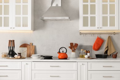 Photo of Set of different utensils and dishes on countertop in kitchen