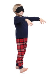 Boy in pajamas and sleep mask sleepwalking on white background