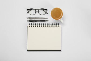 Photo of Flat lay composition with open notebook and coffee on white table