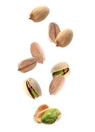 Image of Tasty pistachio nuts falling on white background 