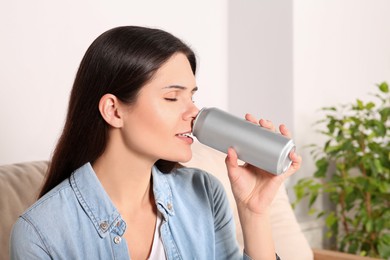 Photo of Woman drinking beverage on sofa at home