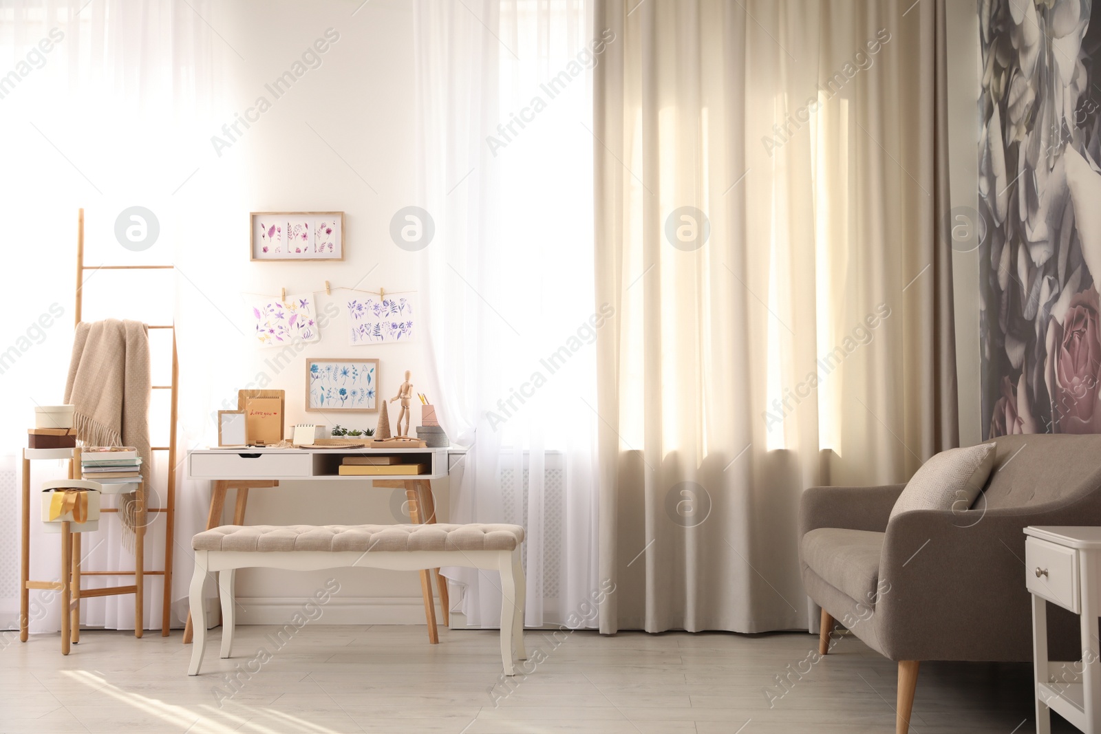 Photo of Stylish room interior with creative workplace near white wall