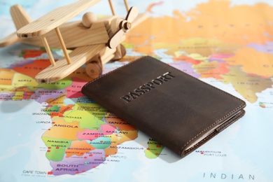 Passport and toy airplane on world map. Travel agency