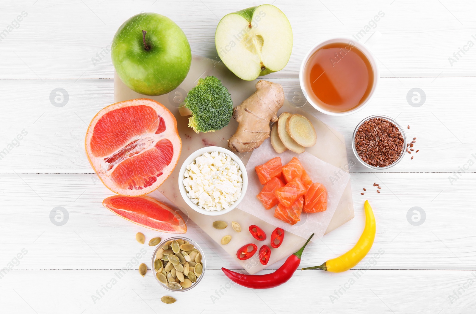 Photo of Metabolism. Different food products on white wooden table, flat lay