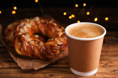 Delicious coffee and pastries on wooden table