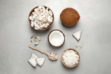 Photo of Flat lay composition with tasty coconut chips on grey table