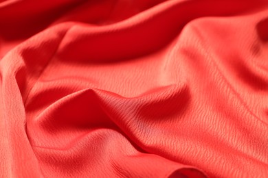 Photo of Texture of red crumpled fabric as background, closeup