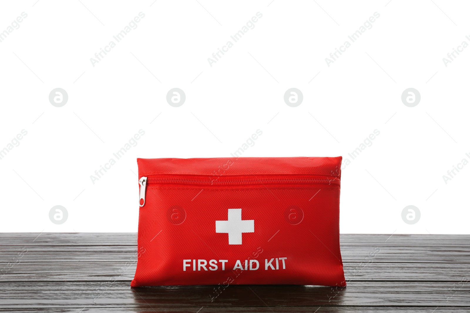 Photo of First aid kit on wooden table against white background