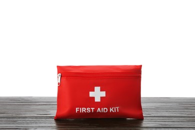 Photo of First aid kit on wooden table against white background