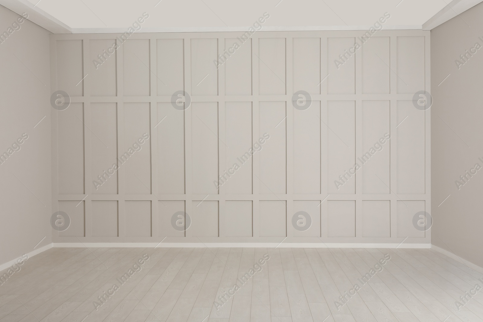 Photo of Empty room with beige walls and laminated flooring